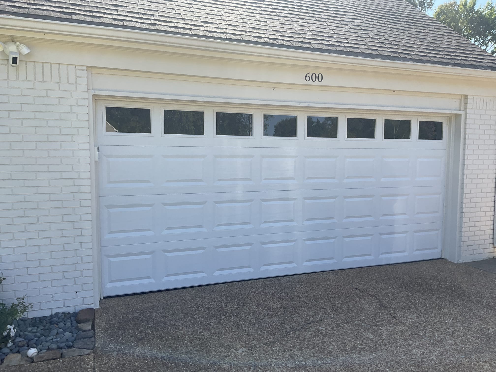 Finished white garage door with a row of windows installed in Greater Memphis