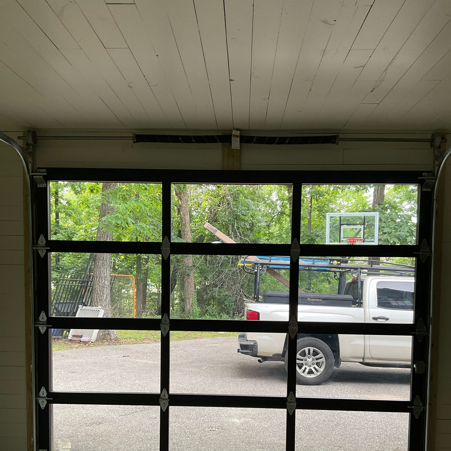 Interior view through a black full-view glass garage door installed in Greater Memphis